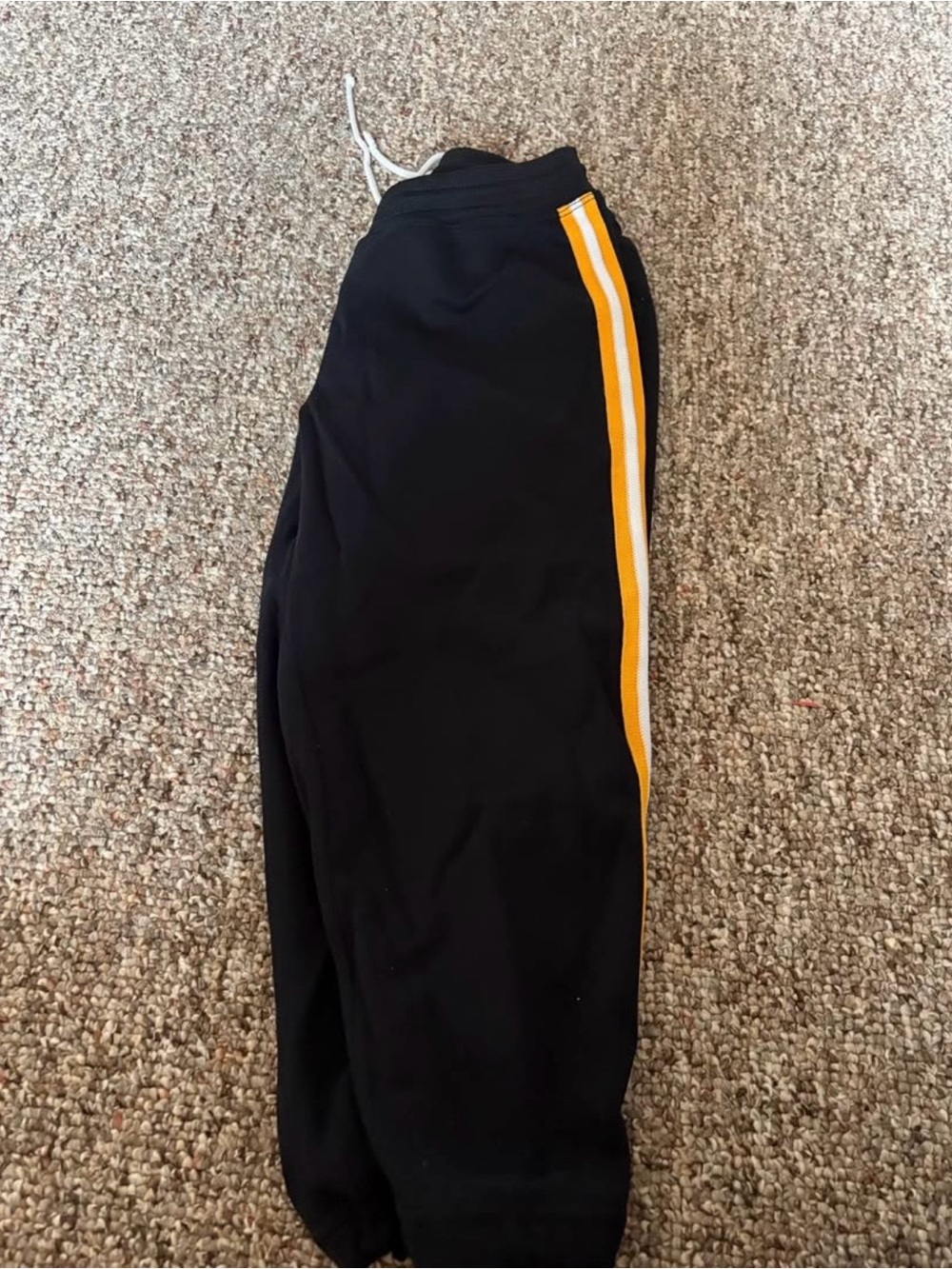 Black softball pants with Yellow and white Stripe